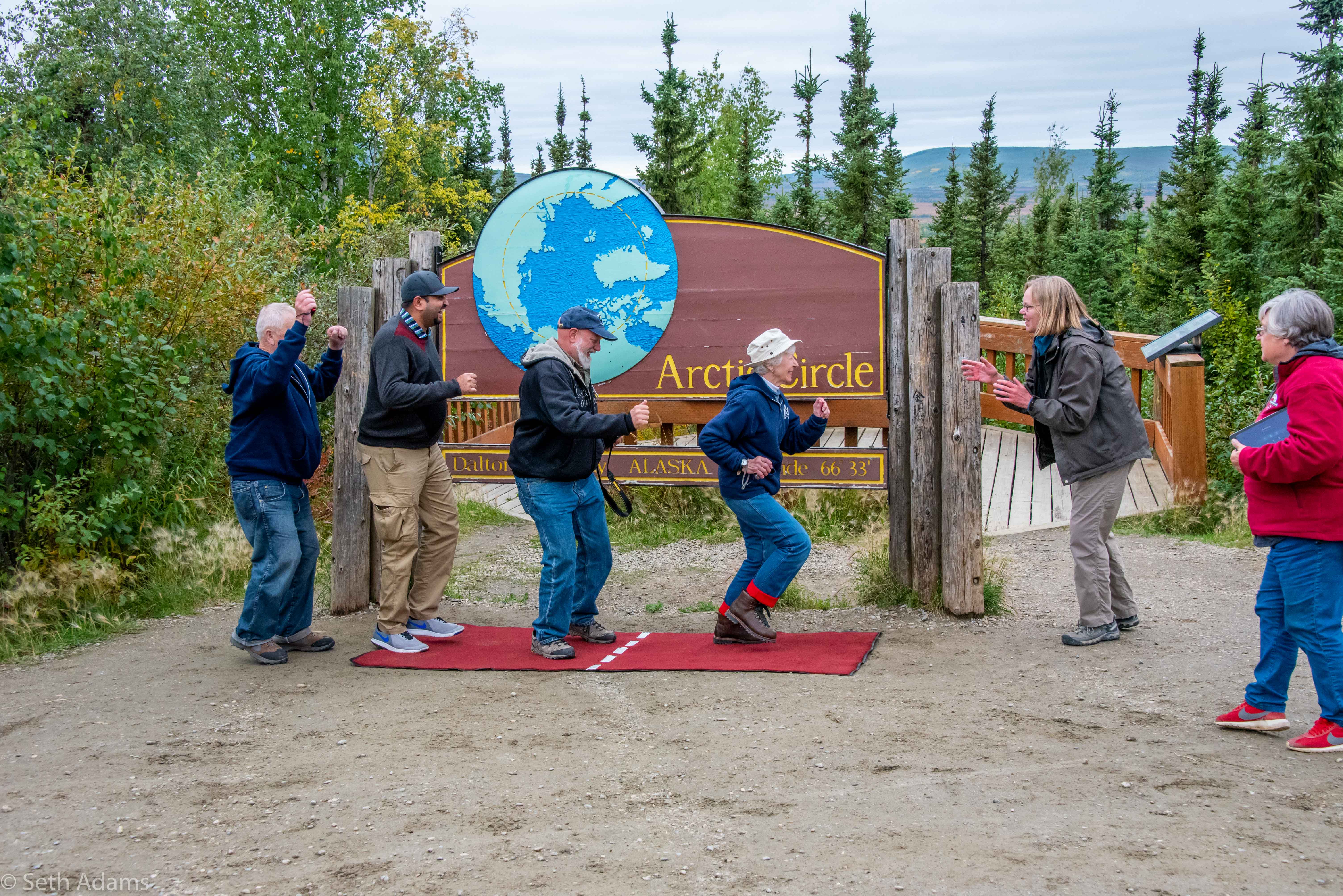 Guide celebrating crossing the Arctic Circle with guests
